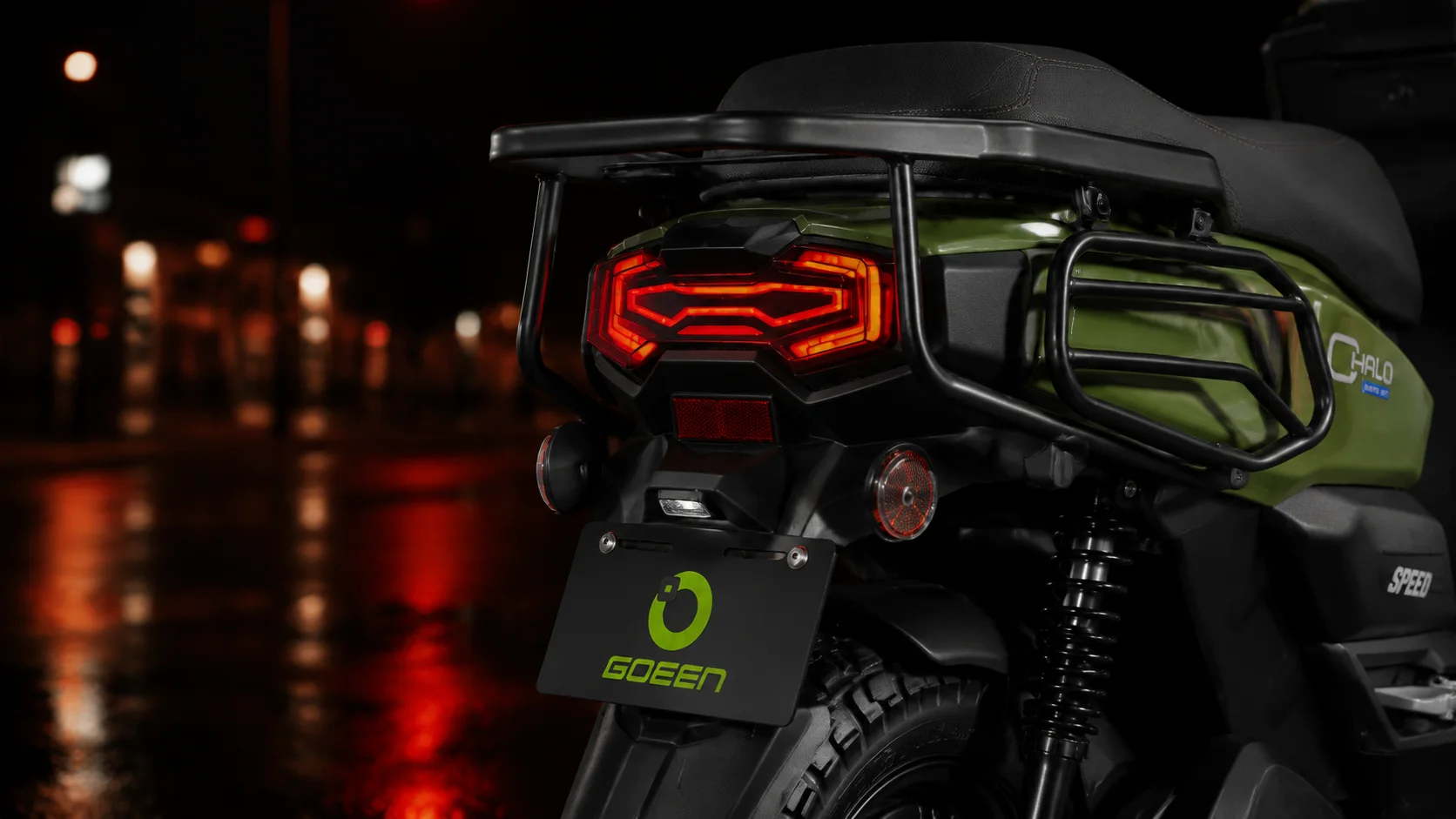 CHALO 1000 V2 signature LED tail lamp glowing on a wet street at night
